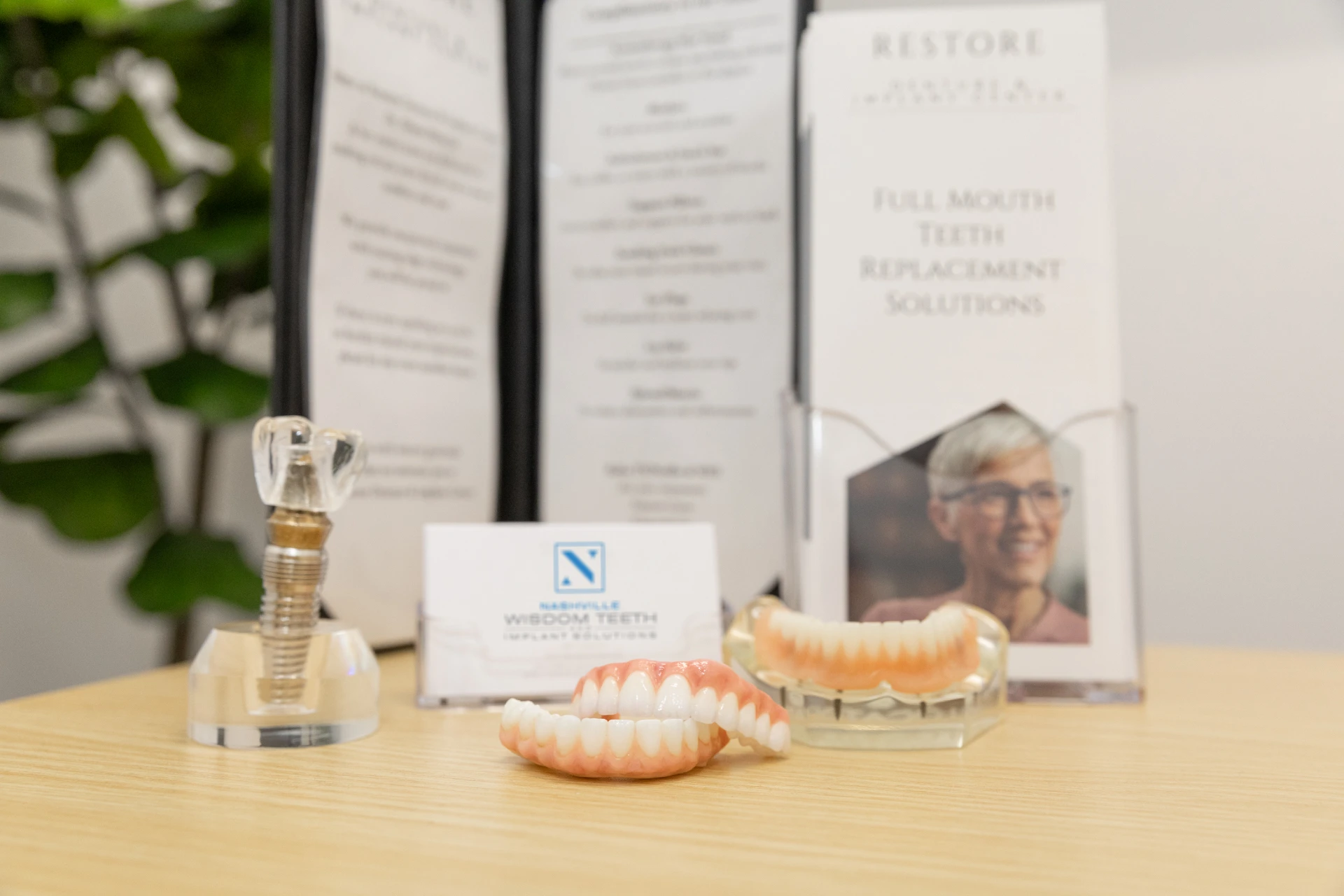 Dental implant options displayed on table. Explore the cost of dental implants in Nashville at Nashville Wisdom Teeth & Implant Solutions